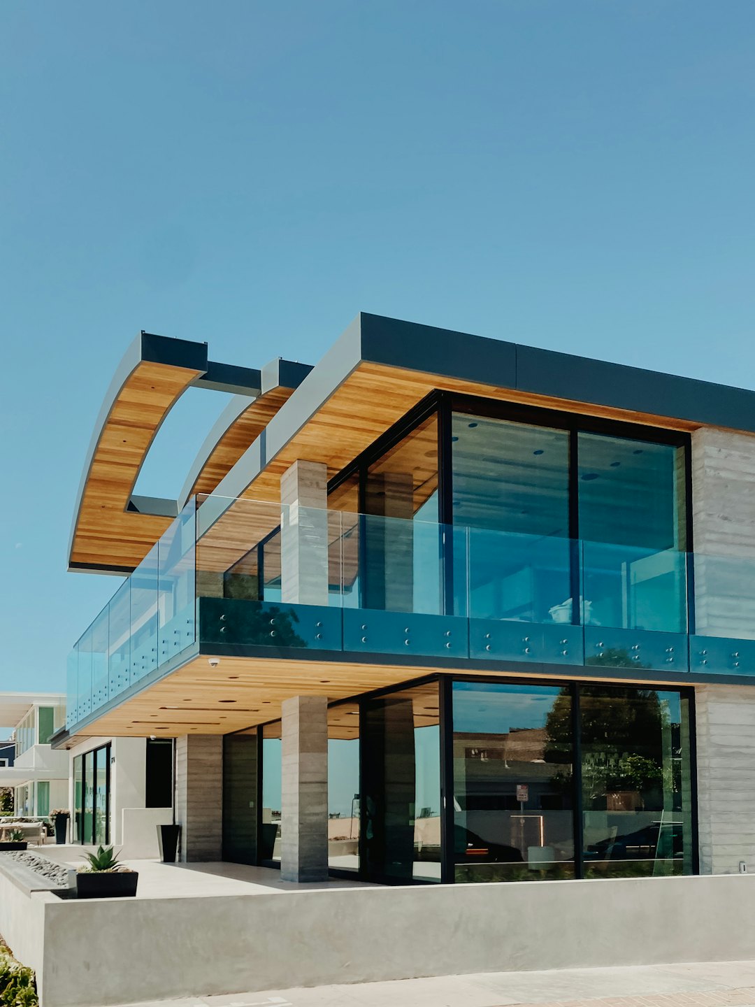 Modern multi-story residential building with wood accents and glass balconies.